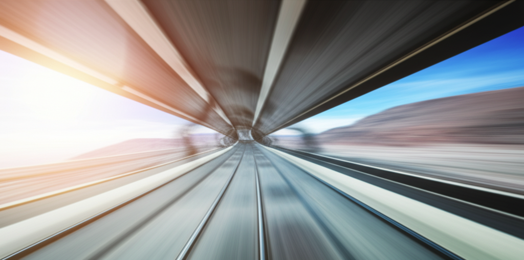 A wide panoramic shot from inside a hyperloop pod, showing a breathtaking landscape rushing past below at high speed,  with a strong emphasis on the vastness and beauty of the view.